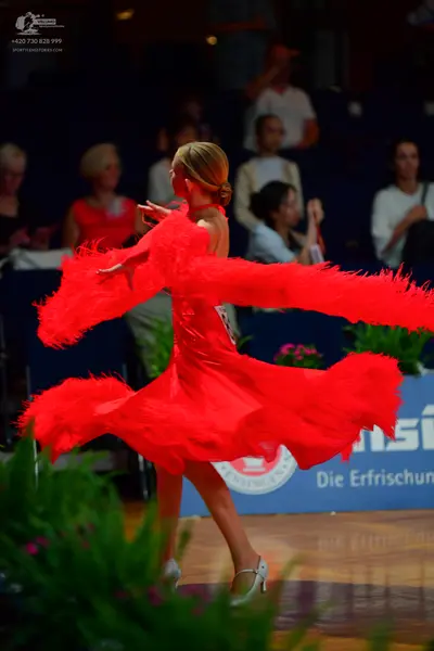 Dancesport competitor: Female dancer: red latin dress with fringe