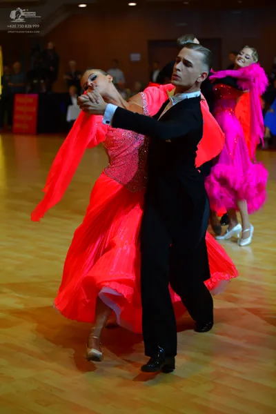 Dancesport competitor: Male dancer: black suit with a white shirt