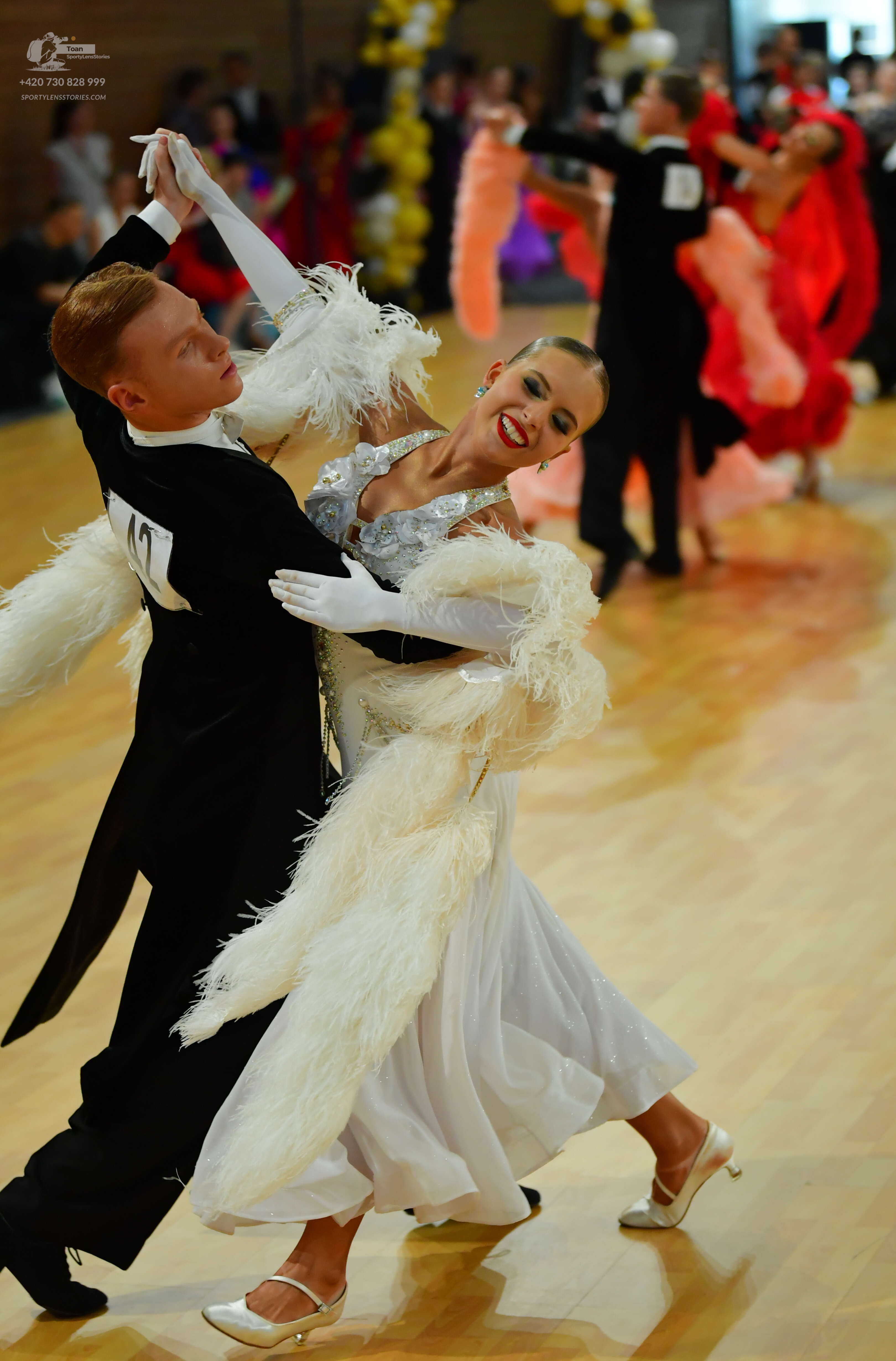 Dancesport competitor: Male:** Black tail suit with silver sequin lapels and cuffs