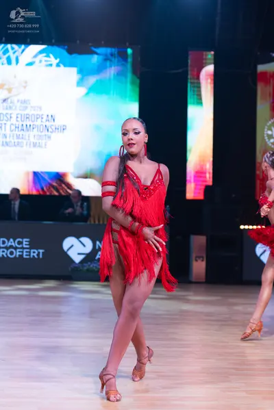 Dancesport competitor: Female dancer: red Latin dress with fringe