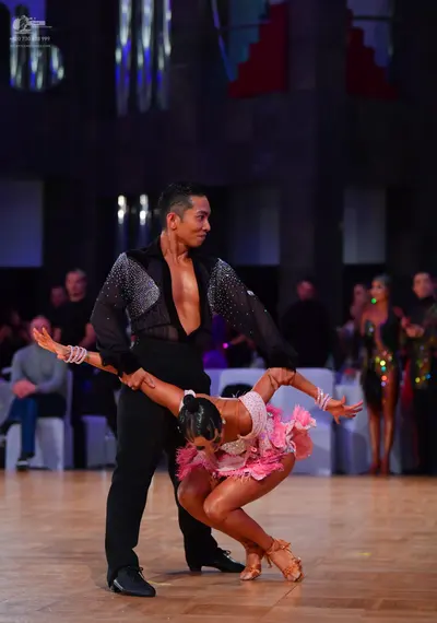 Dancesport competitor: Male dancer: black long-sleeved shirt with sequins on the upper part and black t