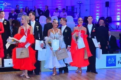 Dancesport competitor: Female dancer: red Latin-style dress with a voluminous ruffled skirt