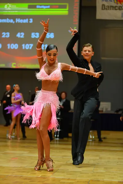 Dancesport competitor: Female dancer: pink latin dress with fringe