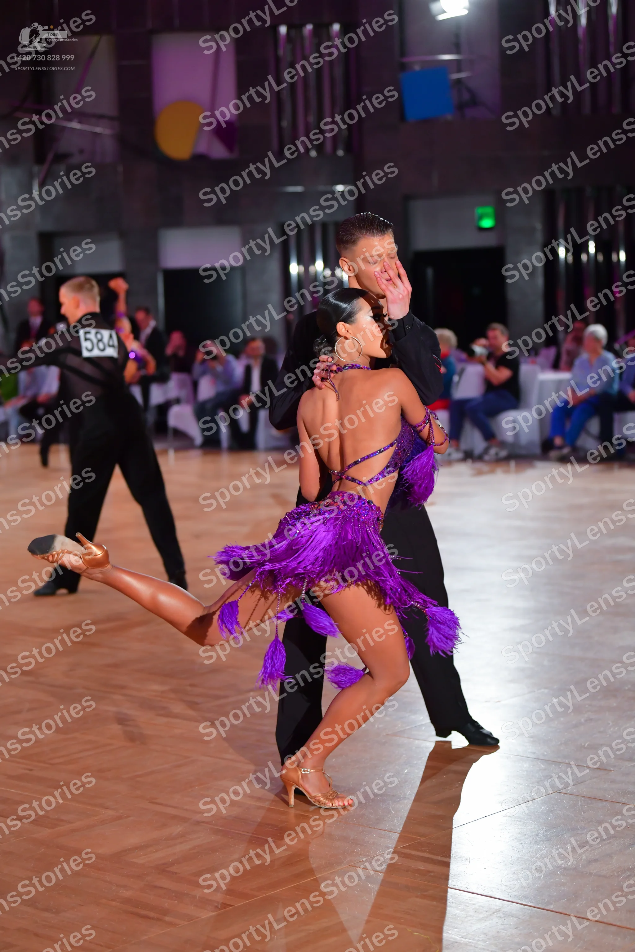 Dancesport competitor #584: Female dancer: purple Latin dress with long fringe