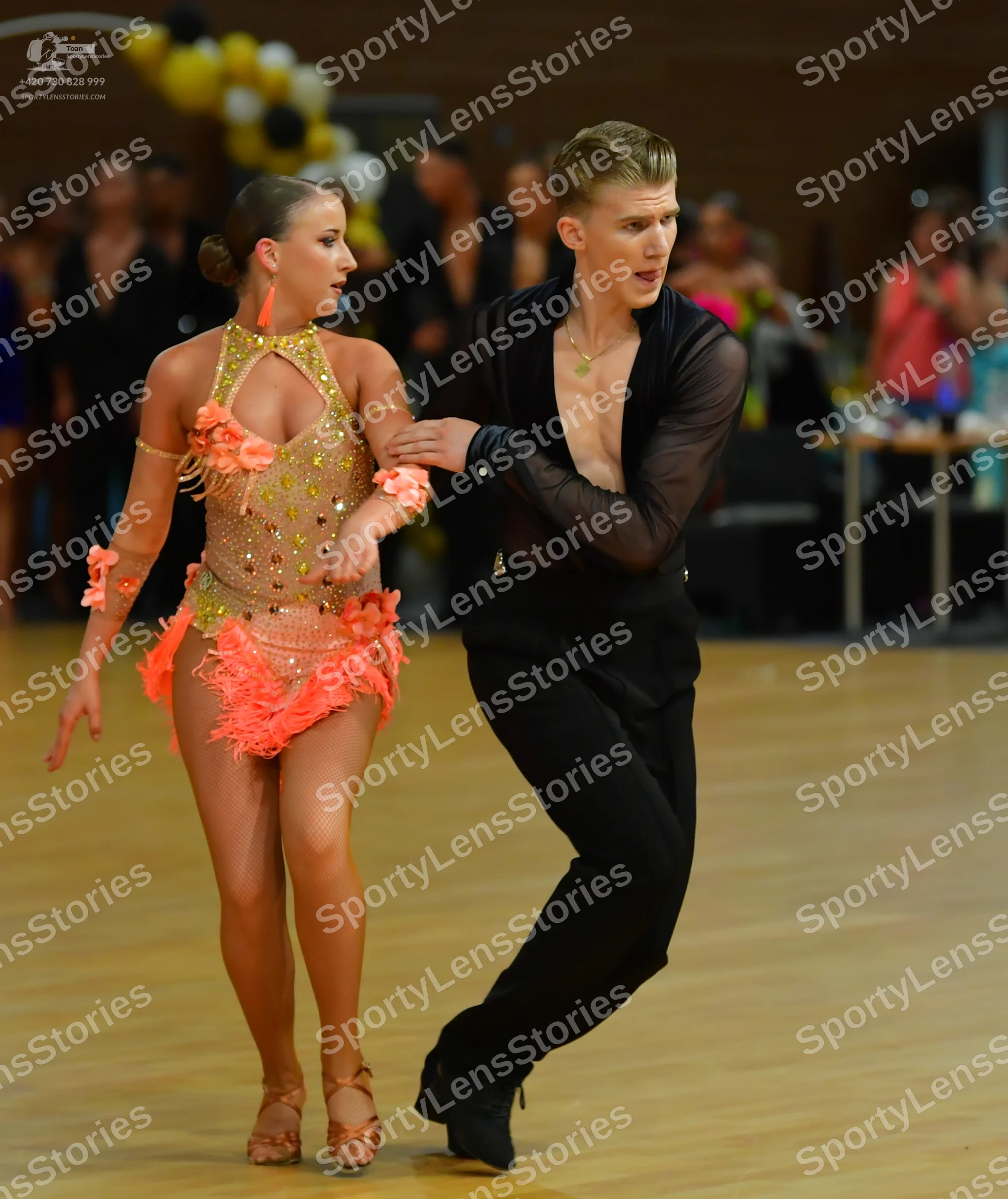 Dancesport competitor: ** Red Latin Dress
*   **Color:** Primarily red
*   **Fabric:** Appears to be a 
