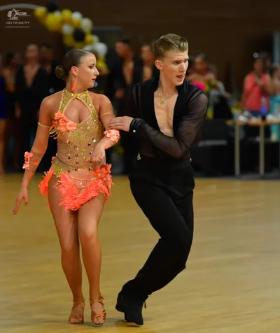 Dancesport competitor: ** Red Latin Dress
*   **Color:** Primarily red
*   **Fabric:** Appears to be a 