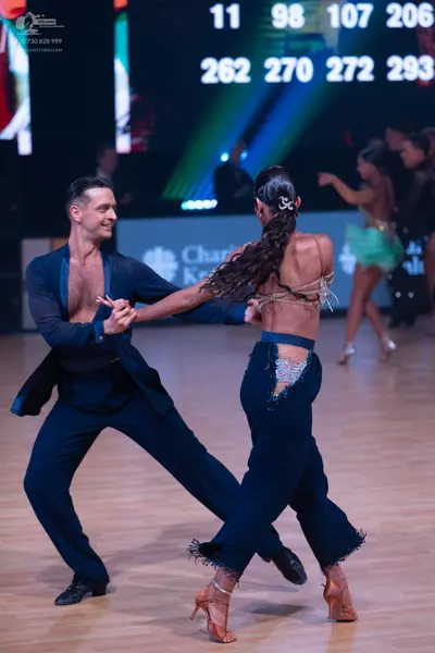 Dancesport competitor: Male dancer: navy blue open-front jacket and matching trousers