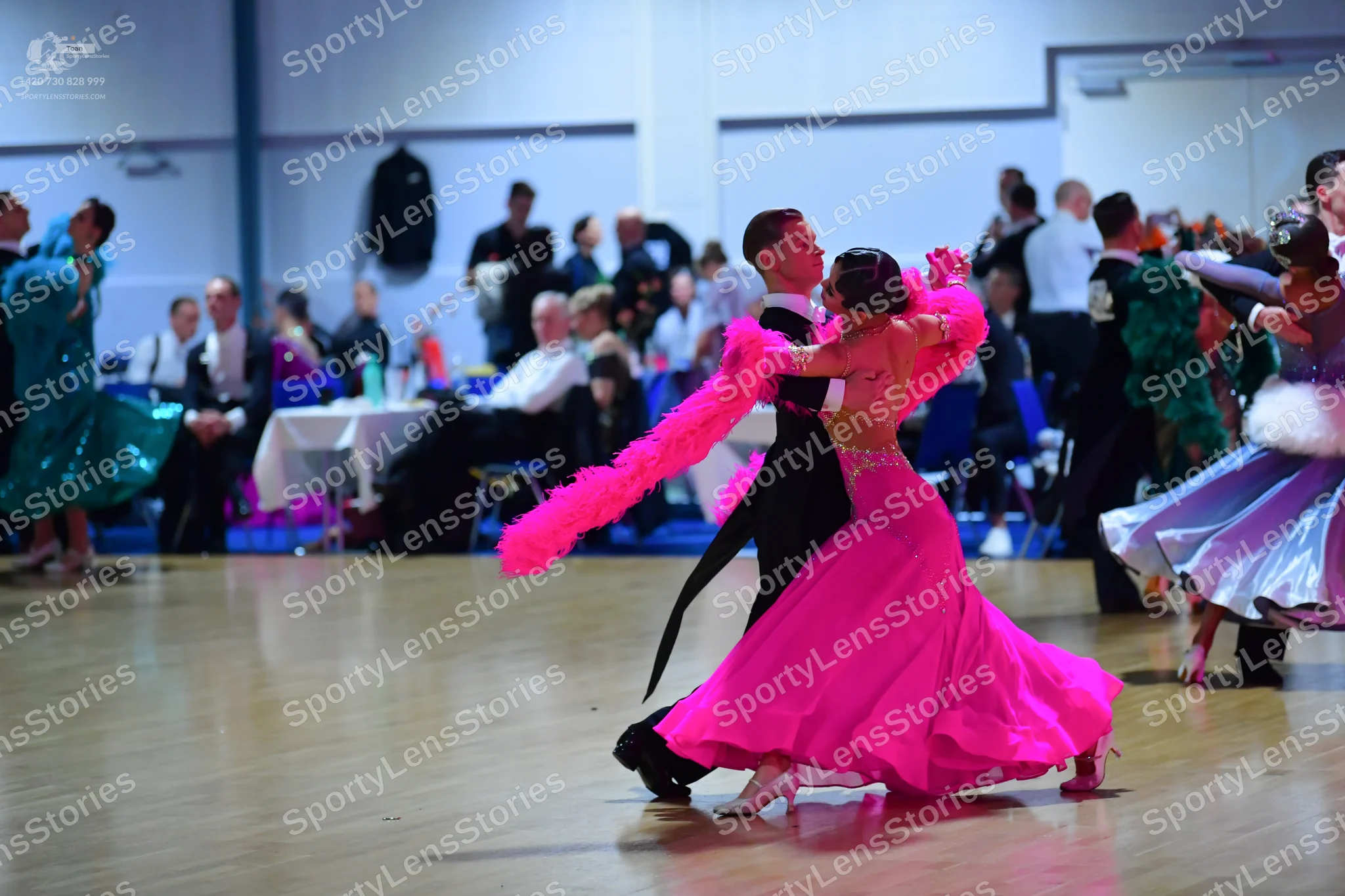 Dancesport competitor: Central male dancer: black suit with white shirt