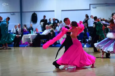 Dancesport competitor: Central male dancer: black suit with white shirt