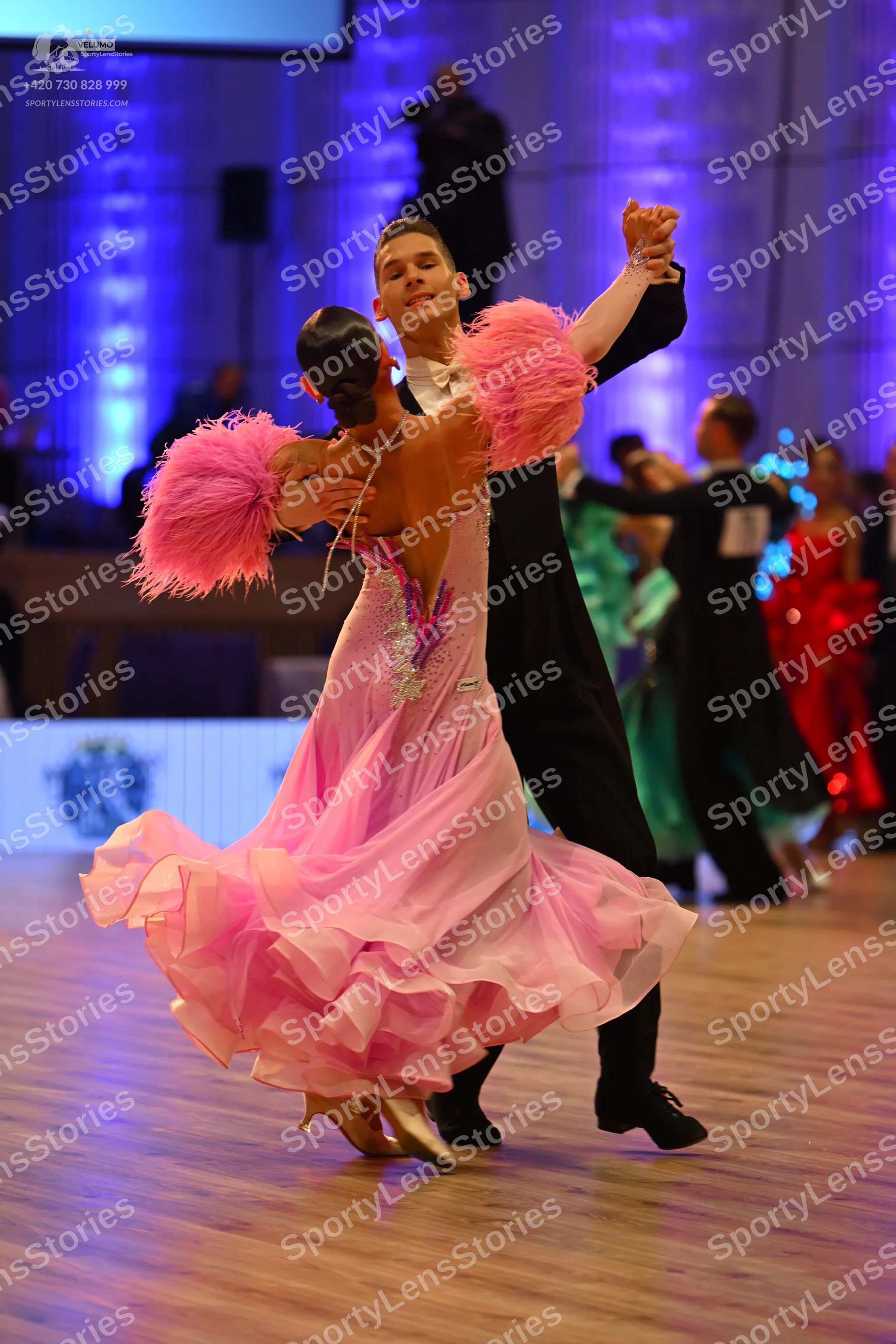 Dancesport competitor: Main female dancer: pink multilayered ruffled ballgown with a sparkly bodice