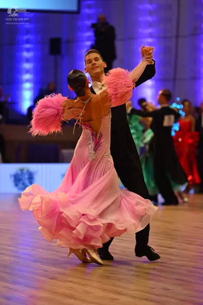 Dancesport competitor: Main female dancer: pink multilayered ruffled ballgown with a sparkly bodice