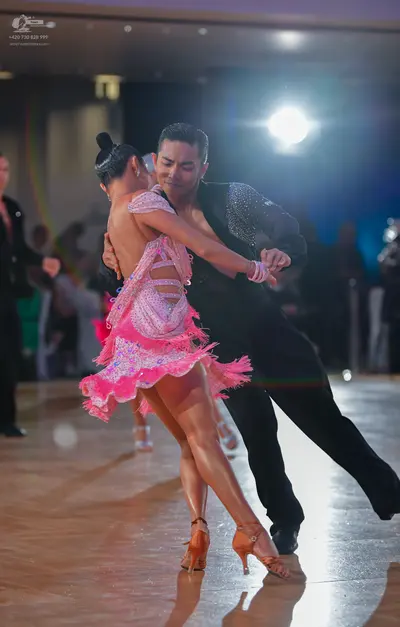 Dancesport competitor: Female dancer: pink Latin dance dress with sequins/rhinestones and cut-outs