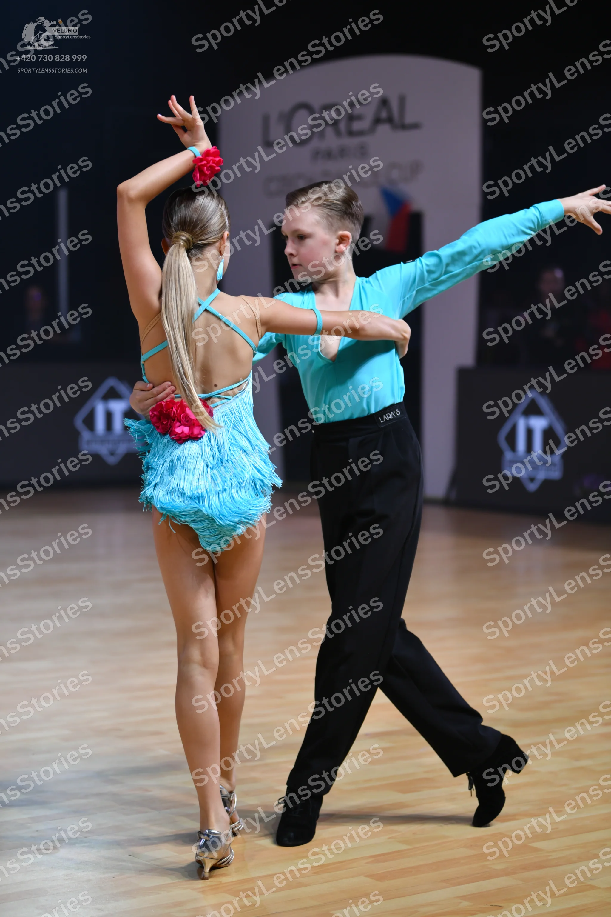 Dancesport competitor: Male dancer: light blue long-sleeved shirt and black trousers