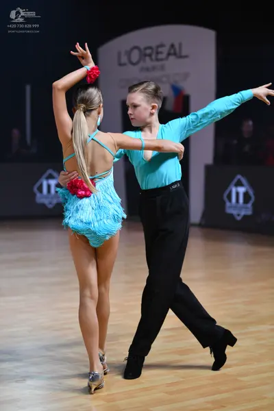 Dancesport competitor: Male dancer: light blue long-sleeved shirt and black trousers