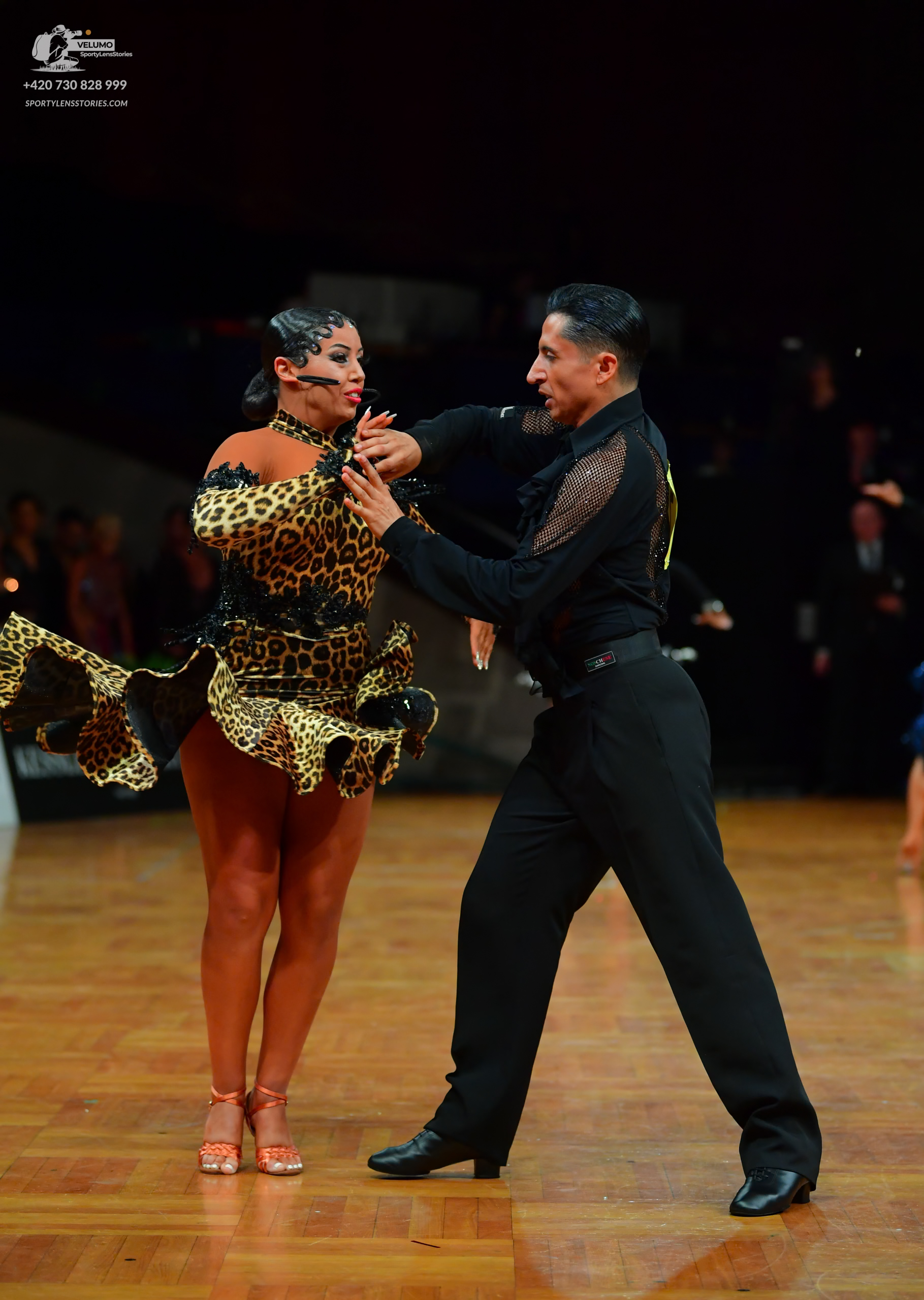 Dancesport competitor: Male dancer: black latin dance shirt with mesh sleeves and black trousers