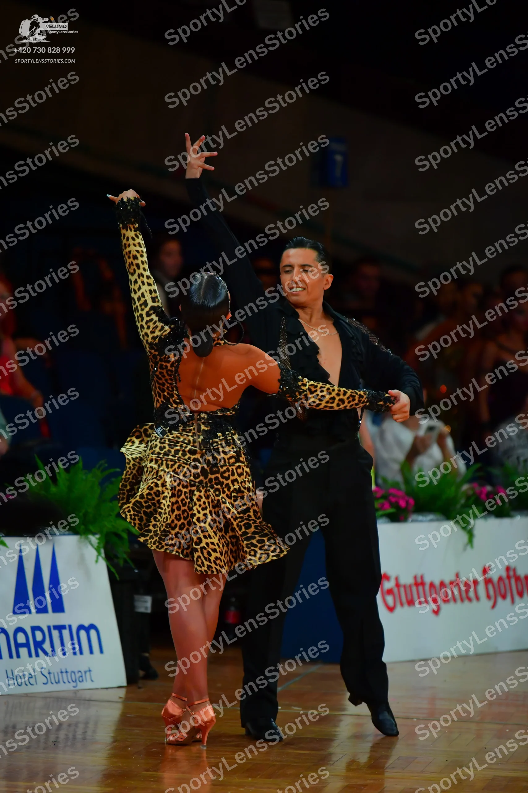 Dancesport competitor: Male dancer: black long-sleeved shirt with subtle patterns on the sleeves and bl