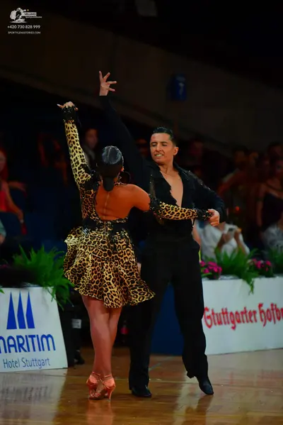 Dancesport competitor: Male dancer: black long-sleeved shirt with subtle patterns on the sleeves and bl