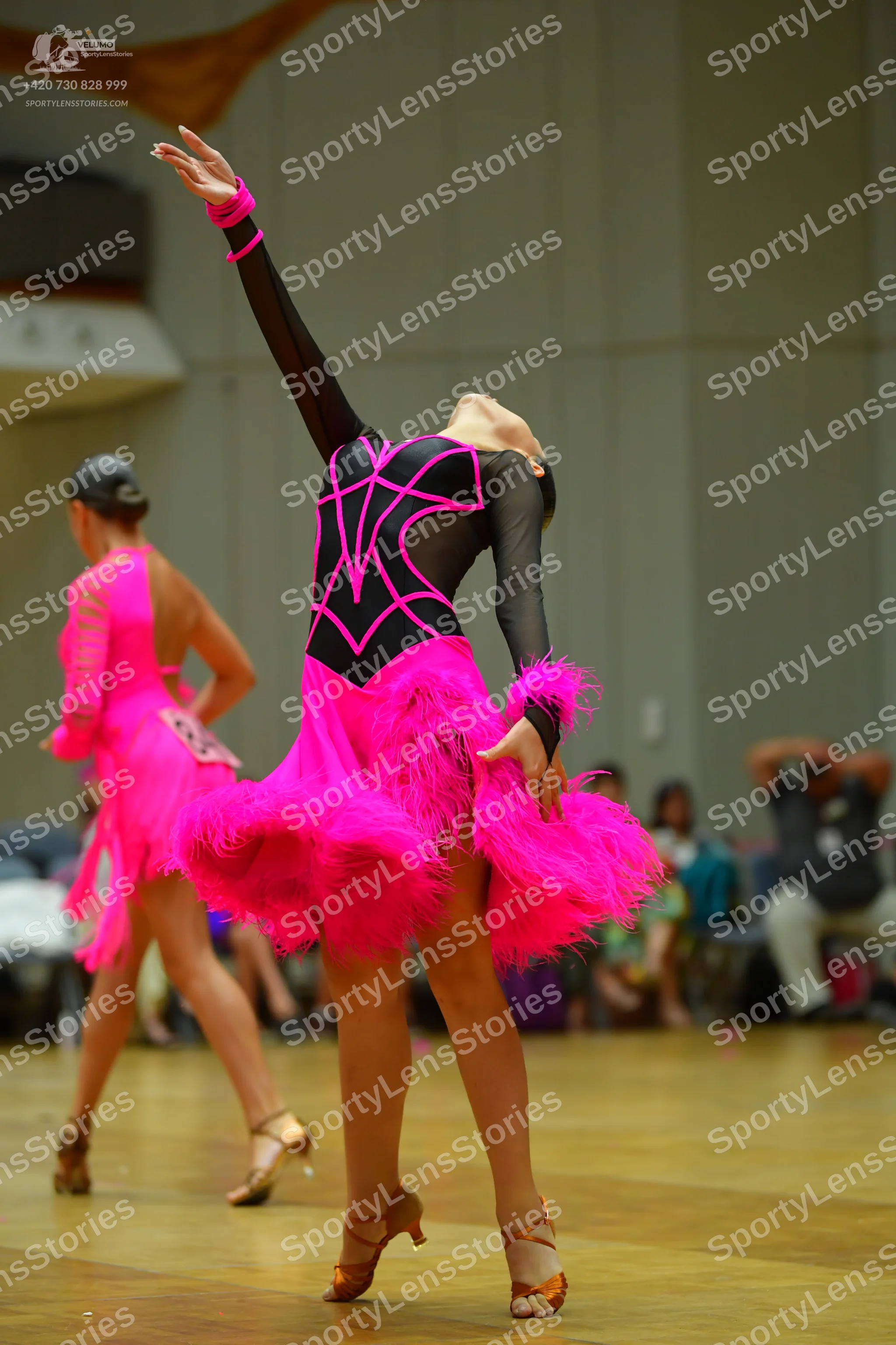Dancesport competitor #96: Female dancer 1: black latin dress with bright pink decorative lines on the bodi
