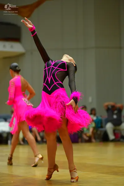 Dancesport competitor #96: Female dancer 1: black latin dress with bright pink decorative lines on the bodi