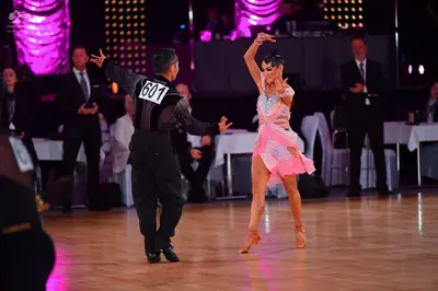 Dancesport competitor #601: Male dancer: black shirt with a textured, shimmering pattern and black trousers