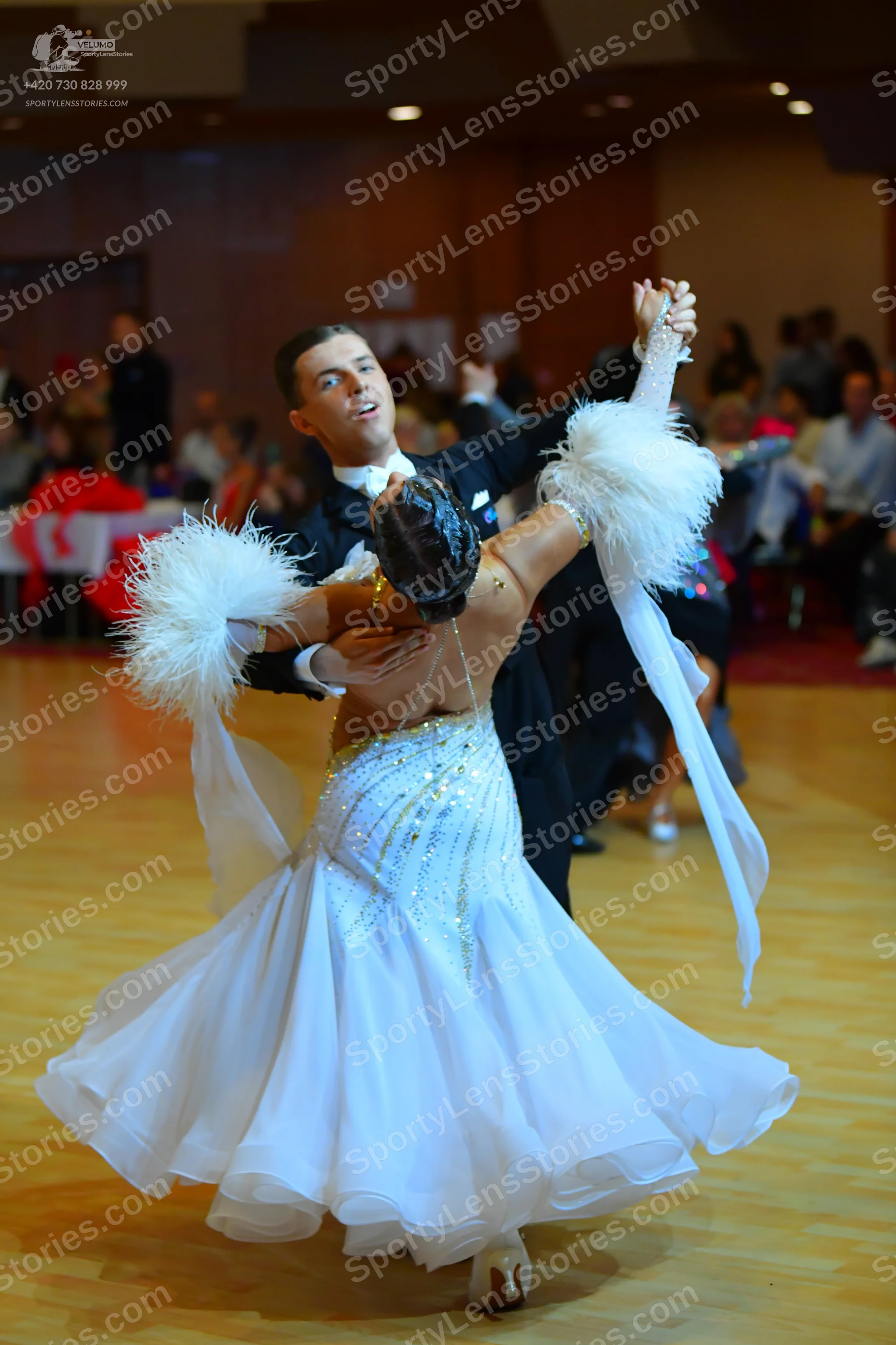 Dancesport competitor: Male dancer: black ballroom suit with a white shirt and white bow tie