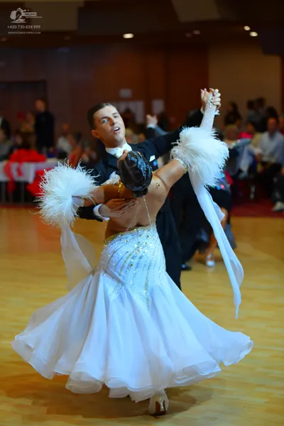 Dancesport competitor: Male dancer: black ballroom suit with a white shirt and white bow tie