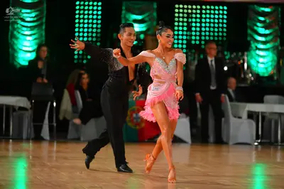 Dancesport competitor: Male dancer: black long-sleeved shirt with sequins and black trousers