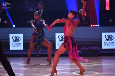 Dancesport competitor: Female dancer 1: blue latin dress with sequins and asymmetrical hem