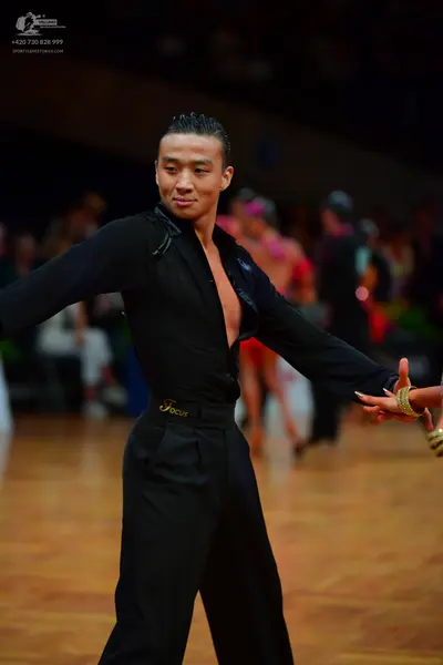 Dancesport competitor: Male dancer: black long-sleeved latin dance shirt, open at the chest, with black