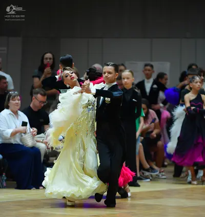 Dancesport competitor: Female dancer: pale yellow voluminous ballgown with sparkly embellishments and m