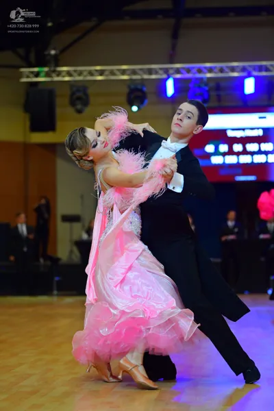 Dancesport competitor: Male dancer: black suit with a white shirt and white bow tie