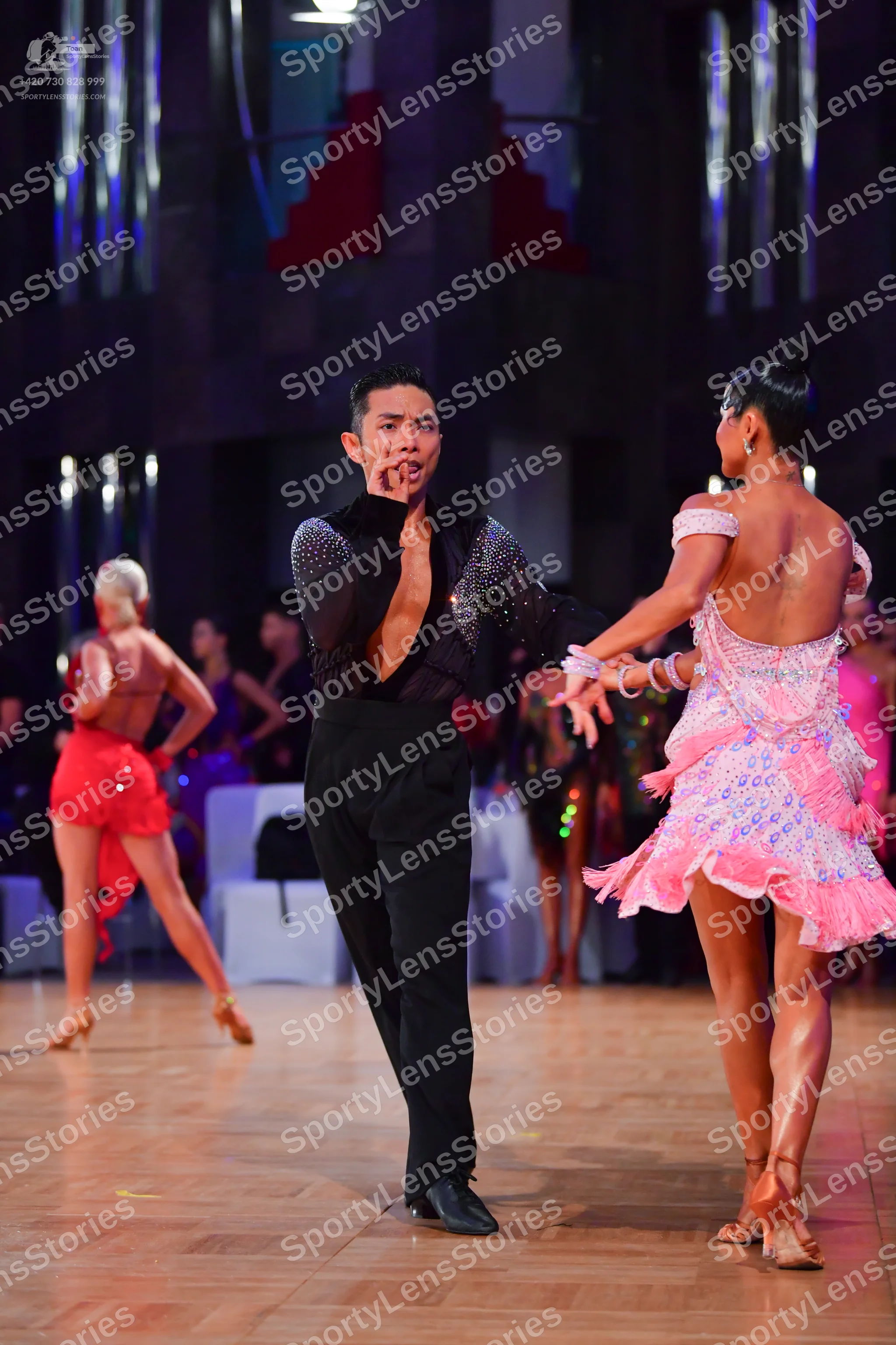 Dancesport competitor: Male dancer: black long-sleeved shirt with sequins on the chest and sleeves, and