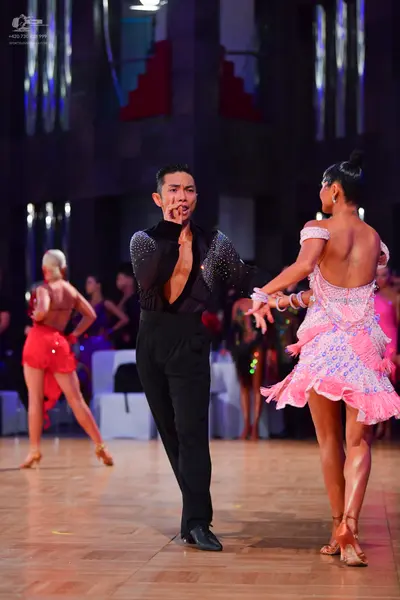 Dancesport competitor: Male dancer: black long-sleeved shirt with sequins on the chest and sleeves, and