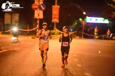 Marathon runner #358, #42210: Runner 1: white tank top, orange shorts, lime green cap, dark shoes