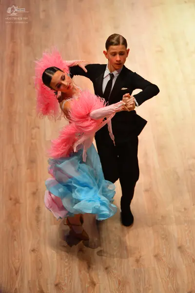 Dancesport competitor: Male dancer: black suit with a white shirt and black tie