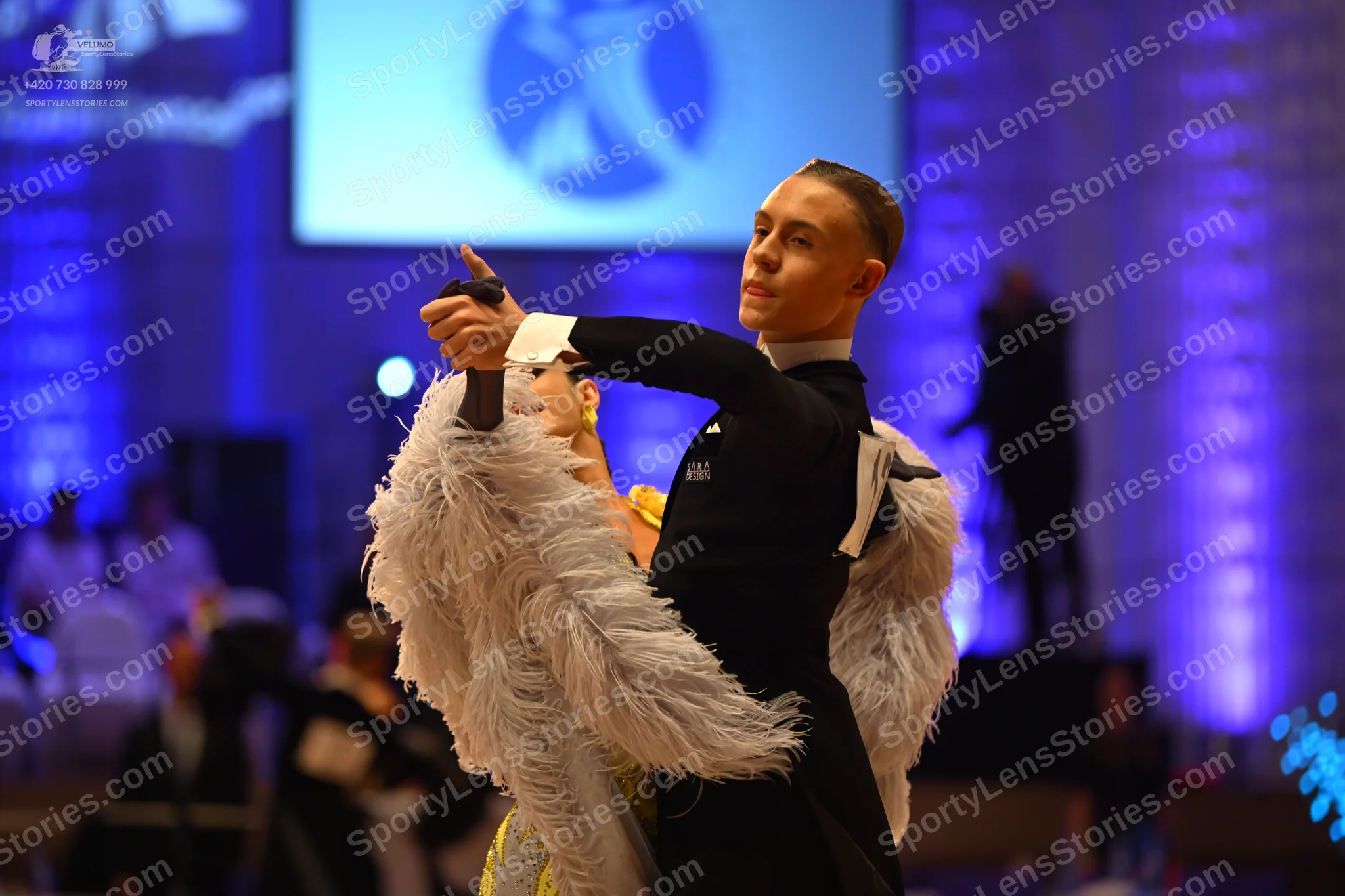 Dancesport competitor: Male dancer: black suit with white cuffs