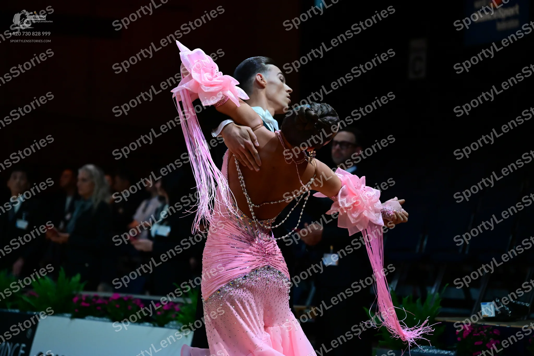 Dancesport competitor: Female dancer: light pink latin dress with large pink fabric flowers on the slee