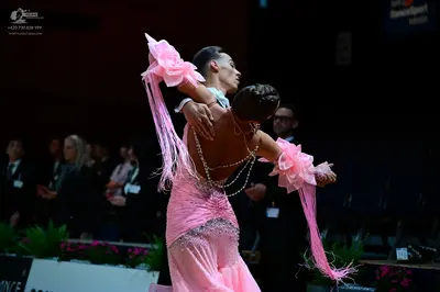 Dancesport competitor: Female dancer: light pink latin dress with large pink fabric flowers on the slee
