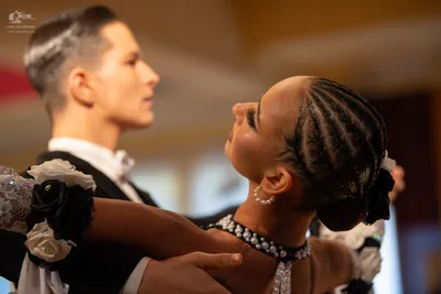 Dancesport competitor: Male dancer: black suit with a white shirt and white bow tie