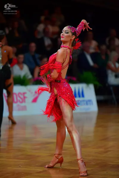 Dancesport competitor: Female dancer: red latin dress with sequins and fringe