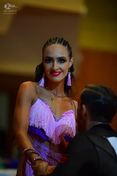 Dancesport competitor: Female dancer: light purple Latin dress with fringe, sequins, and mesh/lace deta