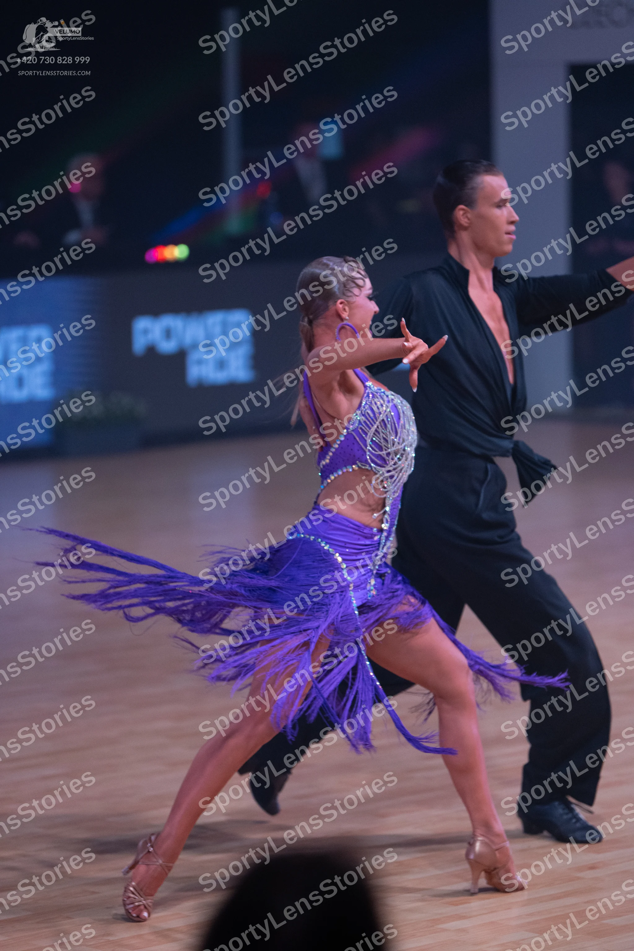 Dancesport competitor: Female dancer: purple Latin dance dress with a sequined/crystal-embellished bodi