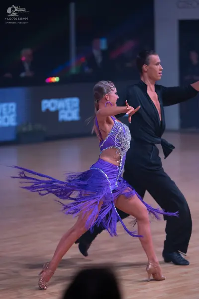 Dancesport competitor: Female dancer: purple Latin dance dress with a sequined/crystal-embellished bodi