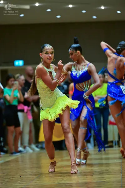 Dancesport competitor: Female dancer 1: yellow sequined latin dress with fringe