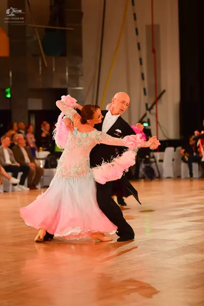 Dancesport competitor: Male dancer: black suit with a white shirt and black bow tie