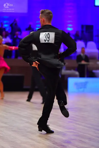 Dancesport competitor: Male dancer: black suit