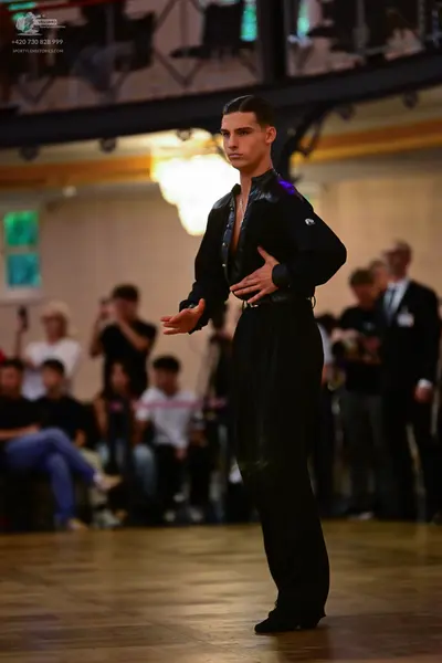 Dancesport competitor: Male dancer: black long-sleeved shirt and black trousers