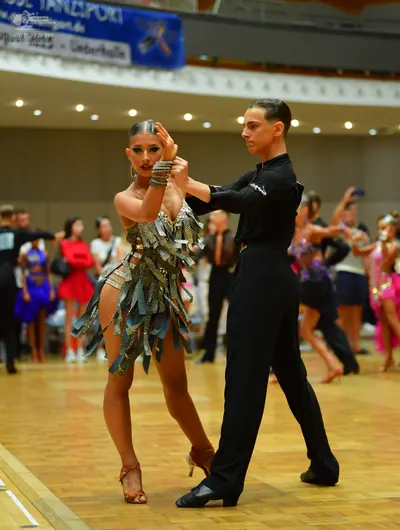 Dancesport competitor: Female dancer: silver metallic latin dress with heavy sequin and fringe embellis