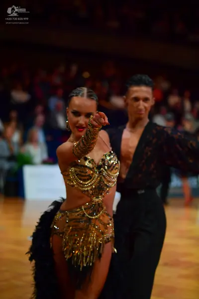 Dancesport competitor: Male dancer: black lace-patterned long-sleeve shirt and black trousers
