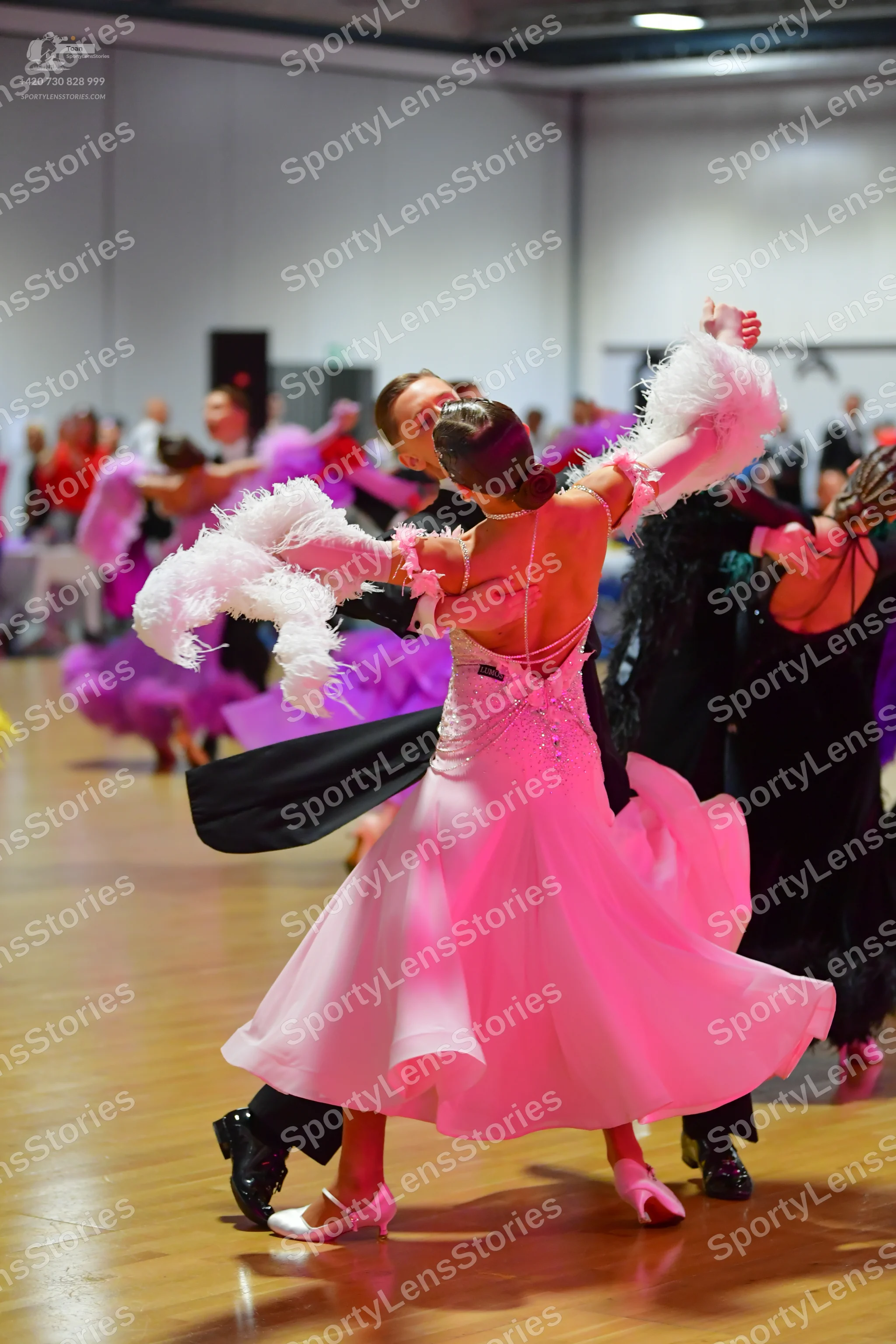 Dancesport competitor: Main female dancer: light pink ballroom dress with a shimmering bodice and large